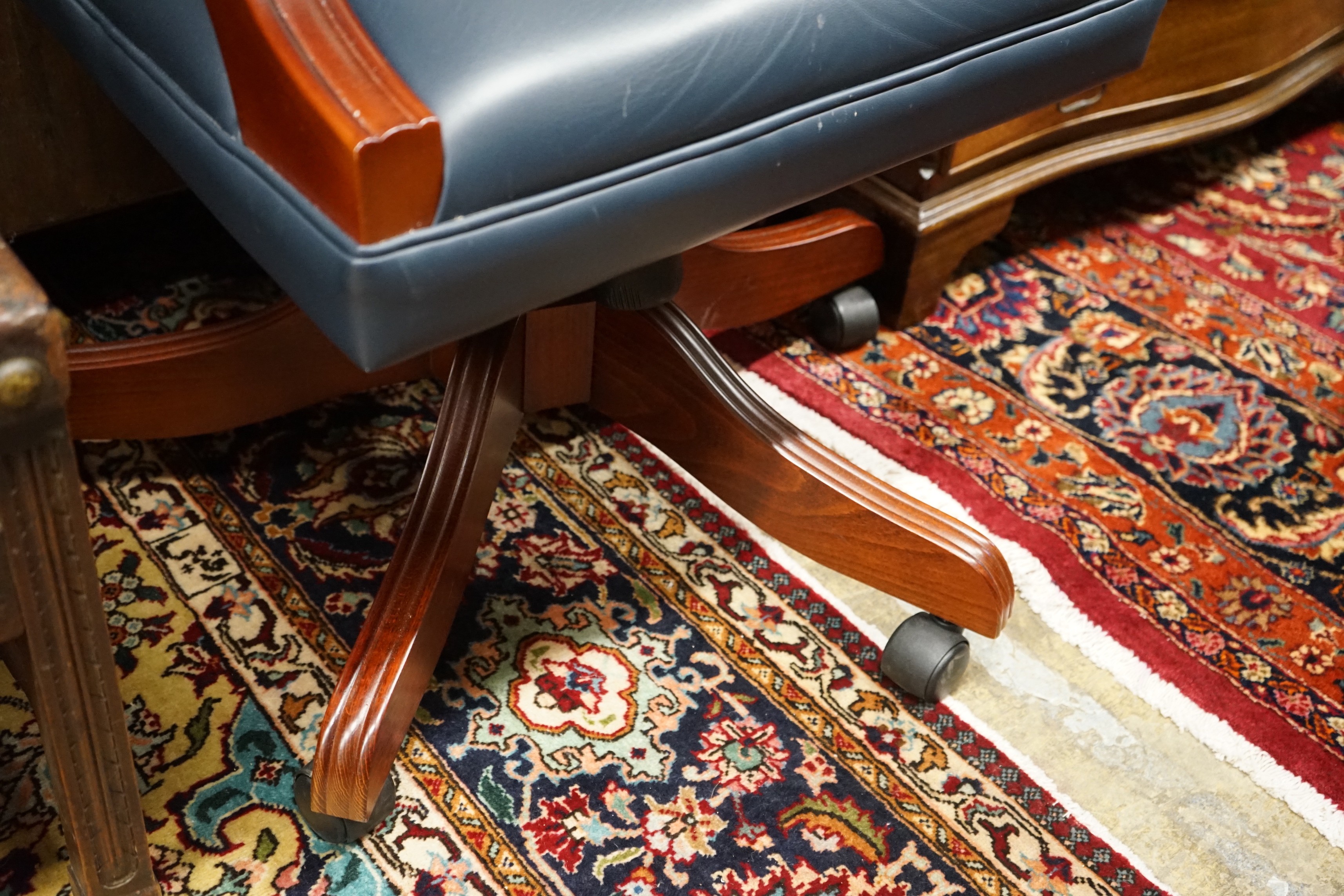 A Regency style mahogany blue buttoned leather swivel desk chair, width 58cm, depth 55cm, height 112cm